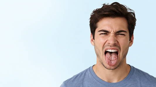 Young man with his mouth open and tongue extended, appearing to experience oral discomfort or dry mouth.