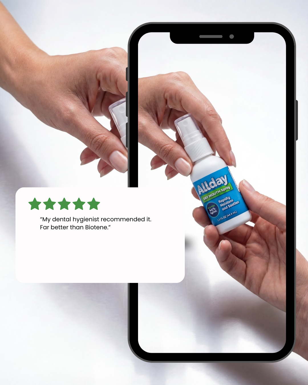 Hand holding a bottle of AllDay Dry Mouth Spray with a phone screen displaying a five-star rating.