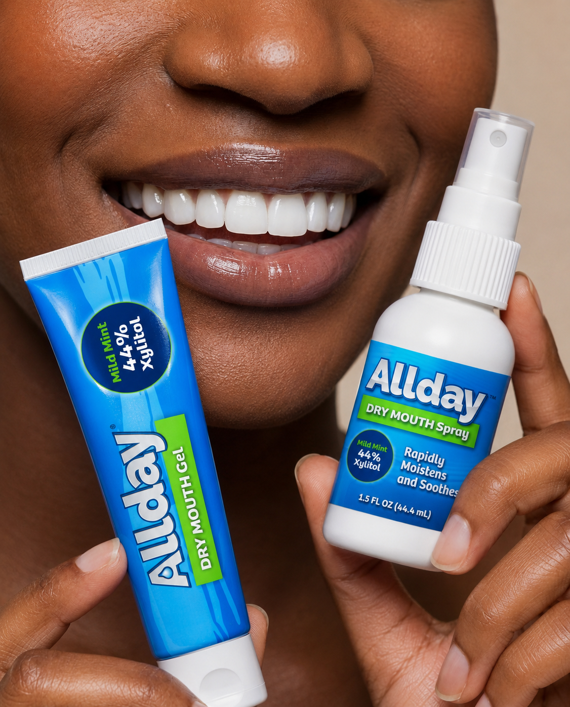 Person holding Allday dry mouth gel and spray with a close-up of a smiling mouth.
